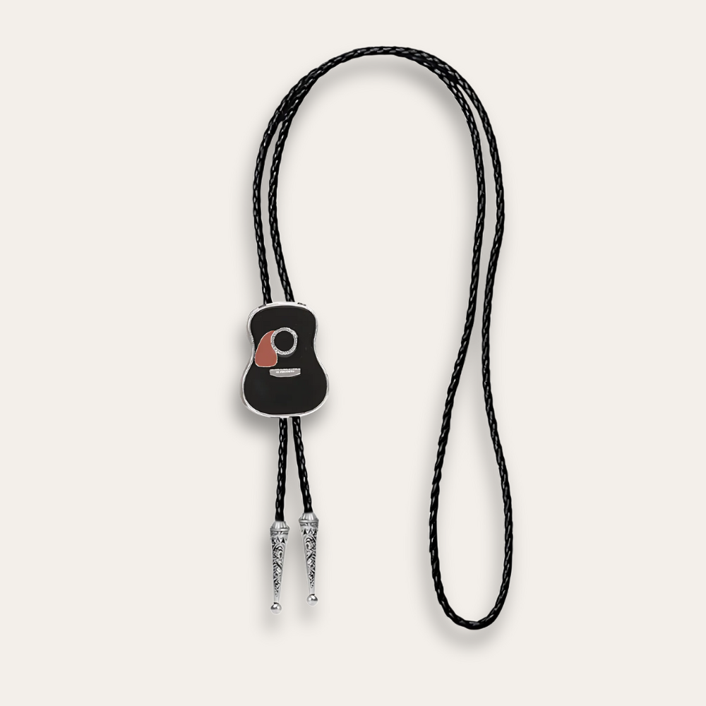 Guitar Bolo Tie, black colorway, the whole piece cut out on a cream ground