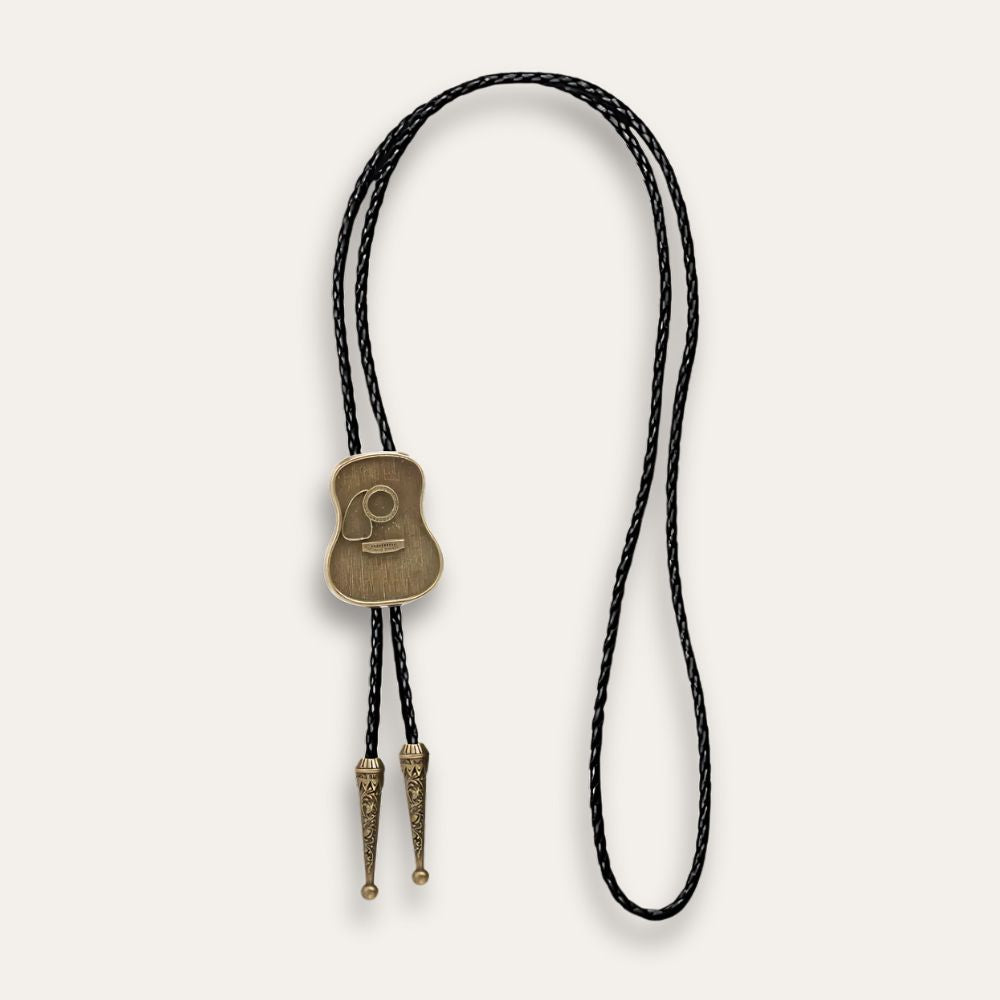 Brown guitar bolo tie laid out at full length, cord tips showing